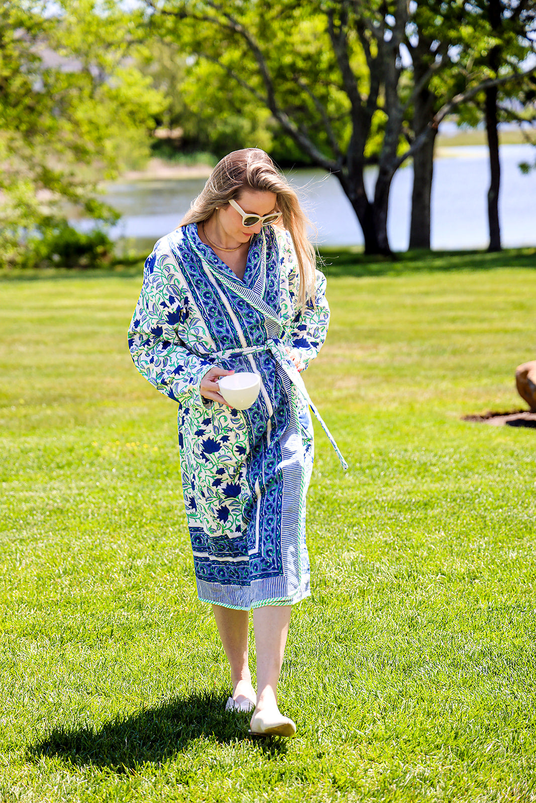 A model wearing the Cosanila Signature Robe and holding a cup outdoors